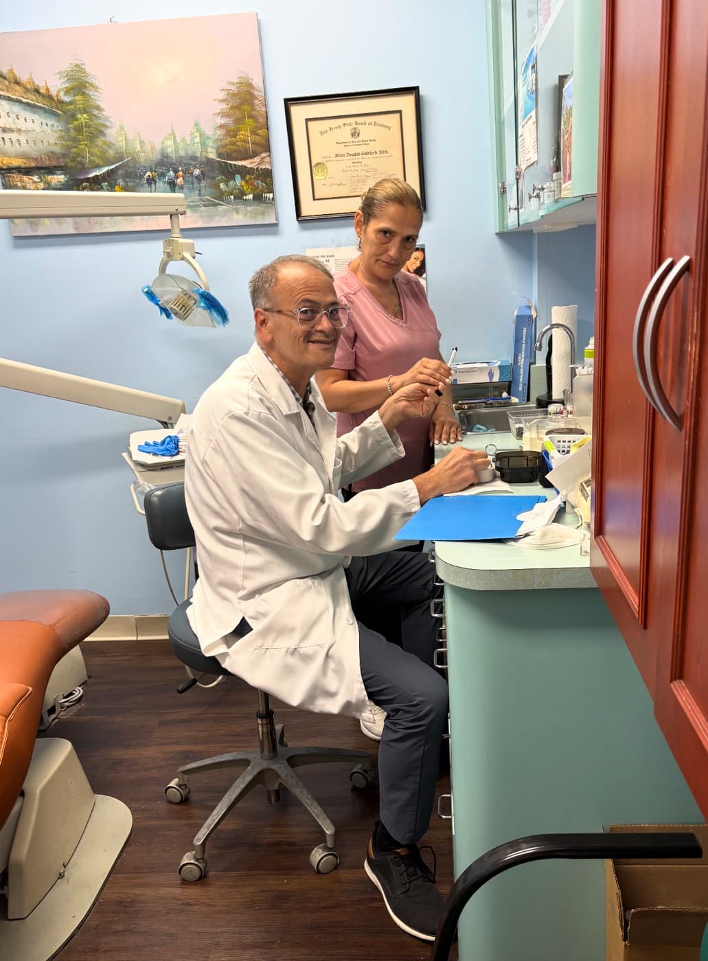 Dr. Allan Goldfarb treating a patient chairside in the Dyker Heights dental office