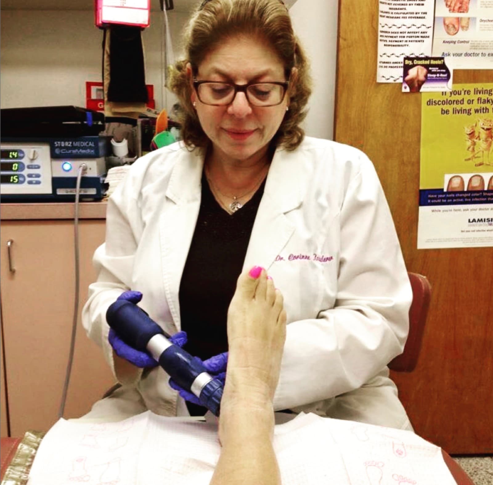 Dr. Corinne Kauderer performing EPAT shockwave therapy on a patient's foot